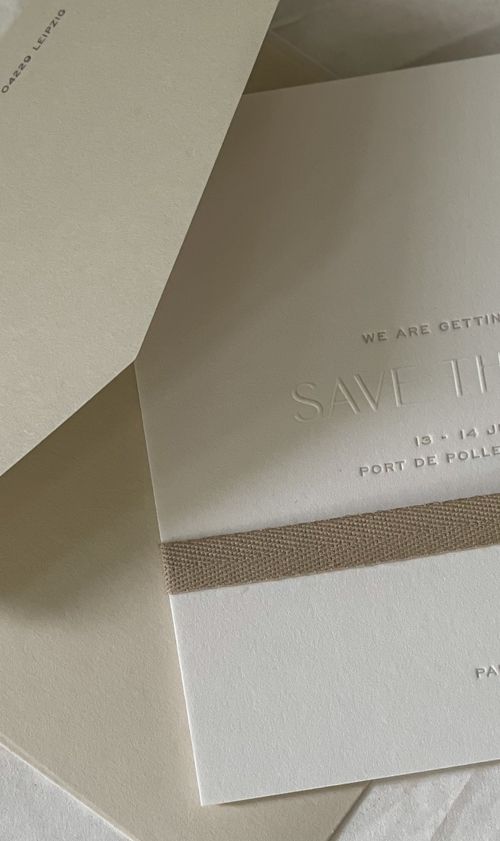 Letterpress save the date card with a cotton ribbon, sent twelve months before Paula and Timo's destination wedding at La Fortaleza, Mallorca