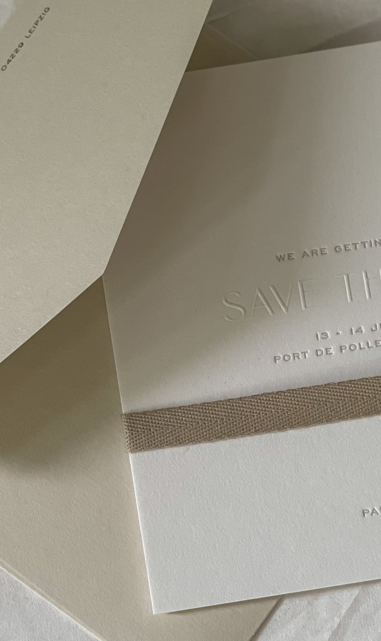 Letterpress save the date card with a cotton ribbon, sent twelve months before Paula and Timo's destination wedding at La Fortaleza, Mallorca